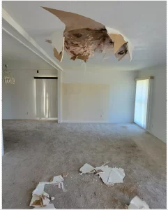 An empty room with a large hole in the ceiling